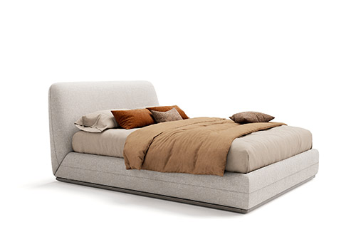 Cama tapizada gris con almohadas marfil o rojas y una manta beige